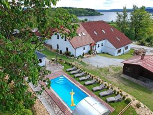 an aerial view of a house with a swimming pool at EDER- Penzion & Apartmány in Horní Planá