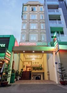 a hotel with a sign on the front of it at Minh Hoang Hotel in Ho Chi Minh City