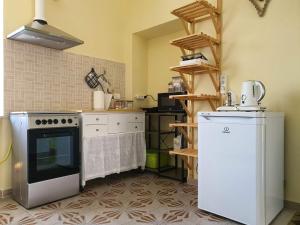 a kitchen with a stove and a refrigerator at Casa soggiorno il Quetzales in Valenza
