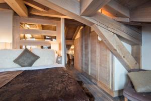 a bedroom with a bed and a wooden ceiling at Chalet Opale in Tignes +4 photos
