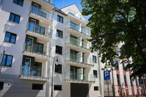 a white apartment building with balconies on it at Apartamenty Bryza-Monte Cassino 8 in Świnoujście