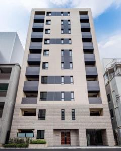 a tall apartment building with many windows at HIZ HOTEL Ginza in Tokyo