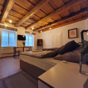 a large bedroom with a large bed and a table at Corte Apartman in Pápa