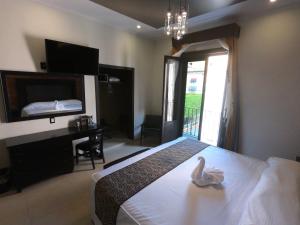 a bedroom with a bed with a swan on it at Hotel San Diego in Guanajuato