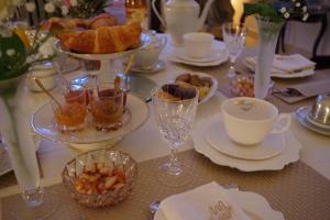 a table with plates of food and cups and drinks at Le Domaine de Prin in Serzy-et-Prin