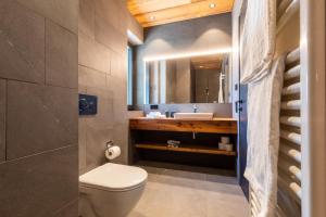 a bathroom with a toilet and a sink at Innerbachlerhof - Gantkofel in Postal +25 photos