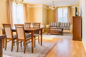 a dining room with a table and chairs and a couch at ApartComplex Splendid in St. St. Constantine and Helena