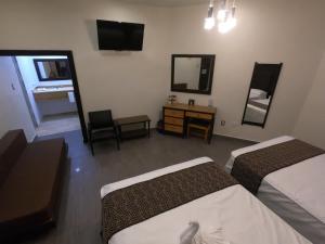 Postel nebo postele na pokoji v ubytování Hotel San Diego