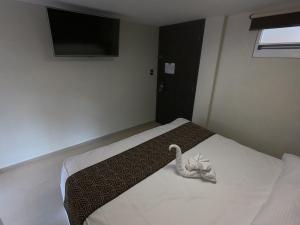 Postel nebo postele na pokoji v ubytování Hotel San Diego
