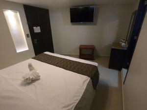 Postel nebo postele na pokoji v ubytování Hotel San Diego