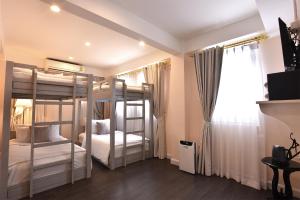Ein Bett oder Betten in einem Zimmer der Unterkunft Noursabah Boutique Bed Bangkok