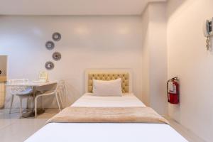 Postel nebo postele na pokoji v ubytování Baymont Suites & Residences