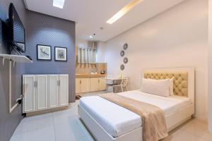 Postel nebo postele na pokoji v ubytování Baymont Suites & Residences