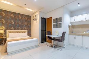 Postel nebo postele na pokoji v ubytování Baymont Suites & Residences