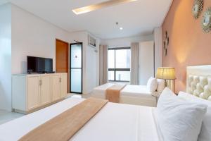 Postel nebo postele na pokoji v ubytování Baymont Suites & Residences + 21 fotografií