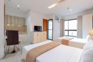Postel nebo postele na pokoji v ubytování Baymont Suites & Residences