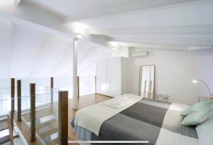 A bed or beds in a room at Pastor Design Suites