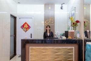 a woman standing at a counter in a salon at Baymont Suites & Residences in Manila