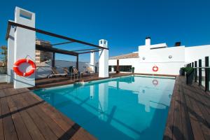 a swimming pool on the roof of a house at Vincci Selección Posada del Patio in Málaga