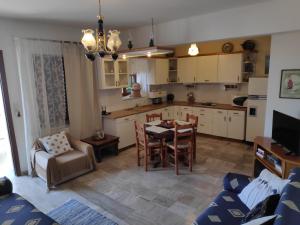 a kitchen and living room with a table and chairs at Harbour View House in Mythimna