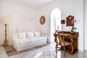 a living room with a white couch and a table at Luxury Relais Villa Magdalena in Ischia