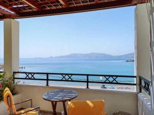 a view of the beach from a balcony with a table and chairs at Haraki Village in Haraki