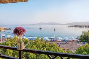 a view of a beach and the ocean from a balcony at Haraki Village in Haraki