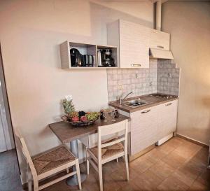 a small kitchen with a table and a sink at Haraki Village in Haraki