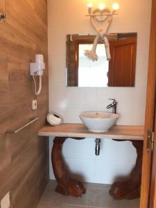 a bathroom with a sink and a mirror at Apartamentos Vista Vedrá in La Savina
