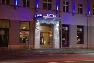 a grand hotel on a city street at night at Hotel Grand in Hradec Králové