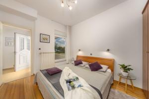 a bedroom with a bed and a window at Terra Magica Deluxe Apartment Or Room with Private Parking, Terrace and Sea View in Rijeka