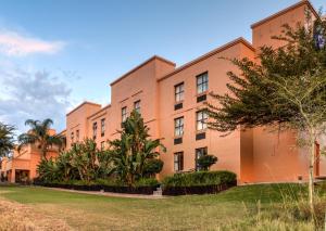 an orange building with trees in front of it at Town Lodge Polokwane in Polokwane