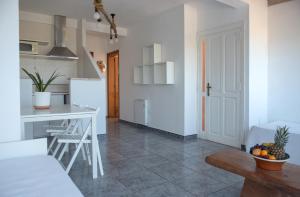 a kitchen and living room with a counter and a table at Apartamentos Vista Vedrá in La Savina