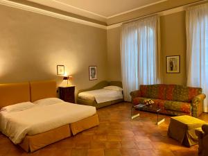 Postel nebo postele na pokoji v ubytování Palazzo Alfani - Residenza d'Epoca