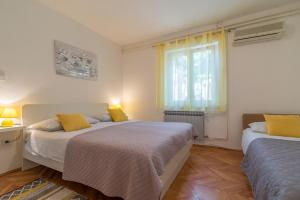 Postel nebo postele na pokoji v ubytování Apartments Tolic
