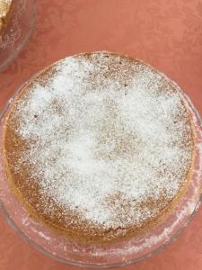 a cake on a glass plate with powdered sugar on it at B&B Magna Graecia in Scalea