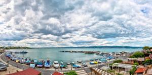 a group of boats docked in a harbor on a river at Panorama Blue Family Hotel and Free parking in Nesebar