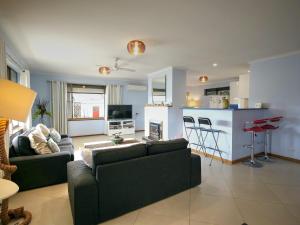 a living room with two couches and a kitchen at Salty Air Apartments Kingscote Kangaroo Island in Kingscote