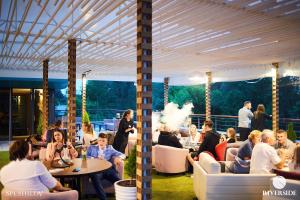 a group of people sitting at tables in a restaurant at RiverSide- Restaurant, Hotel, Beach in Chernihiv