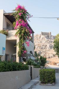 a building with flowers hanging off the side of it at Haraki Village in Haraki