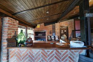 a kitchen with a counter and a brick wall at Hotel Tejera del Nalon in Soto del Barco