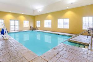 a large pool with blue water in a building at La Quinta by Wyndham Lawton / Fort Sill in Lawton