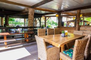 a dining room with a wooden table and chairs at Aprico in Traismauer