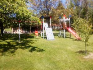 a playground with a slide in a park at Apartamencik na Słonecznej in Piechowice