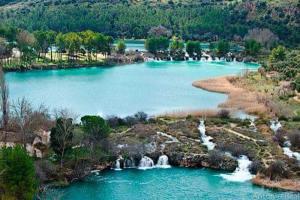 an aerial view of a lake with waterfalls at Jesús Del Perdón in Manzanares