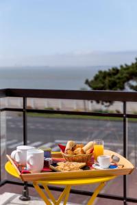 a tray of breakfast food on a table on a balcony at Best Western Hôtel Royan Océan in Royan