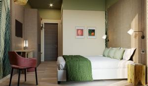 a bedroom with a white bed and a chair at Hotel Life in Rimini