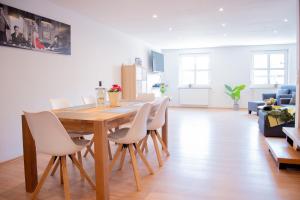 a dining room table and chairs in a living room at Ferienwohnungen Windischeschenbach by HausGruenerBaum in Windischeschenbach