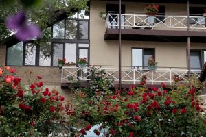 a building with red flowers in front of it at Апартаменти Маяк in Odesa