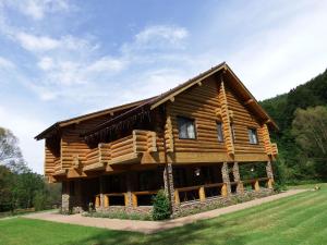 a log cabin in the middle of a field at Casa din Vale in Săcuieu